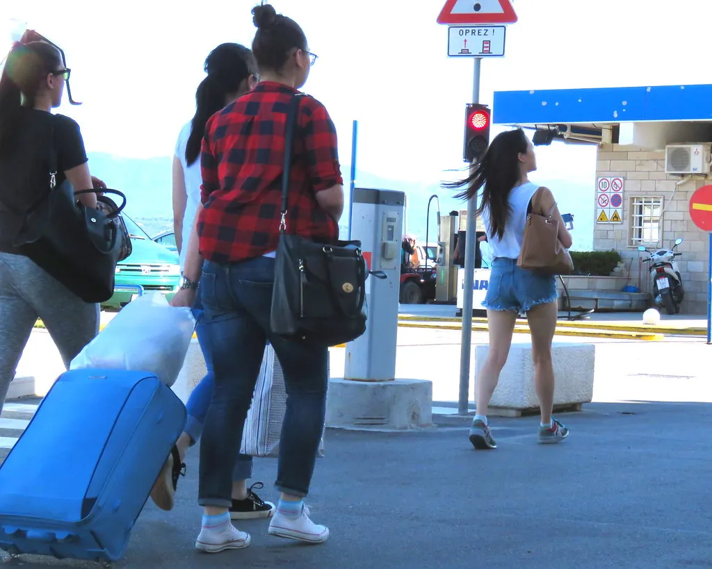 Travelers waiting at a Croatian ferry port in Bol, Brac, illustrating the reality of transport, travel timing and common mistakes tourists make in Croatia