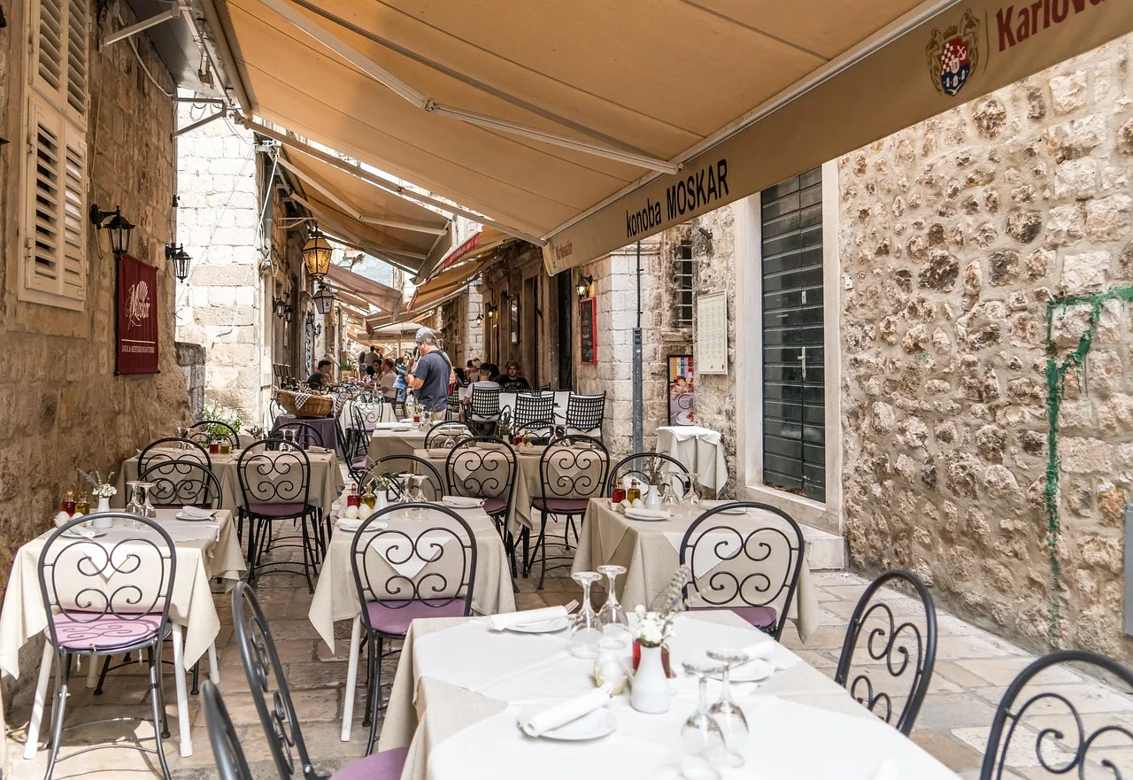 croatia-local-konoba-street-restaurant Small local konoba on a stone street in coastal Croatia, where locals eat away from tourist crowds