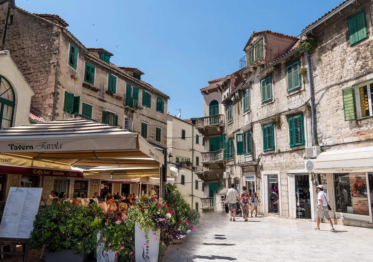 croatia-old-town-split-restaurant-terrace-eating-out Outdoor restaurant terrace in a historic Croatian old town Split, everyday dining scene