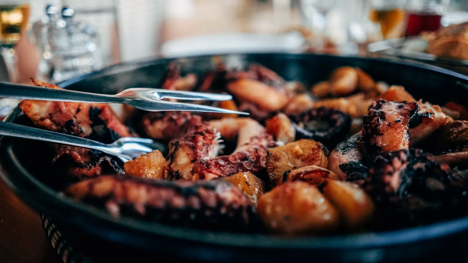 croatian-octopus-peka-traditional-dish Traditional Croatian octopus peka with potatoes, slow-cooked under a bell