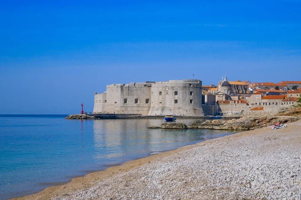 Dubrovnik city walls seen from the coast on a calm day from Banje beach