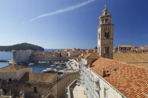 View over Dubrovnik Old Town rooftops and city walls with Lokrum Island in the background