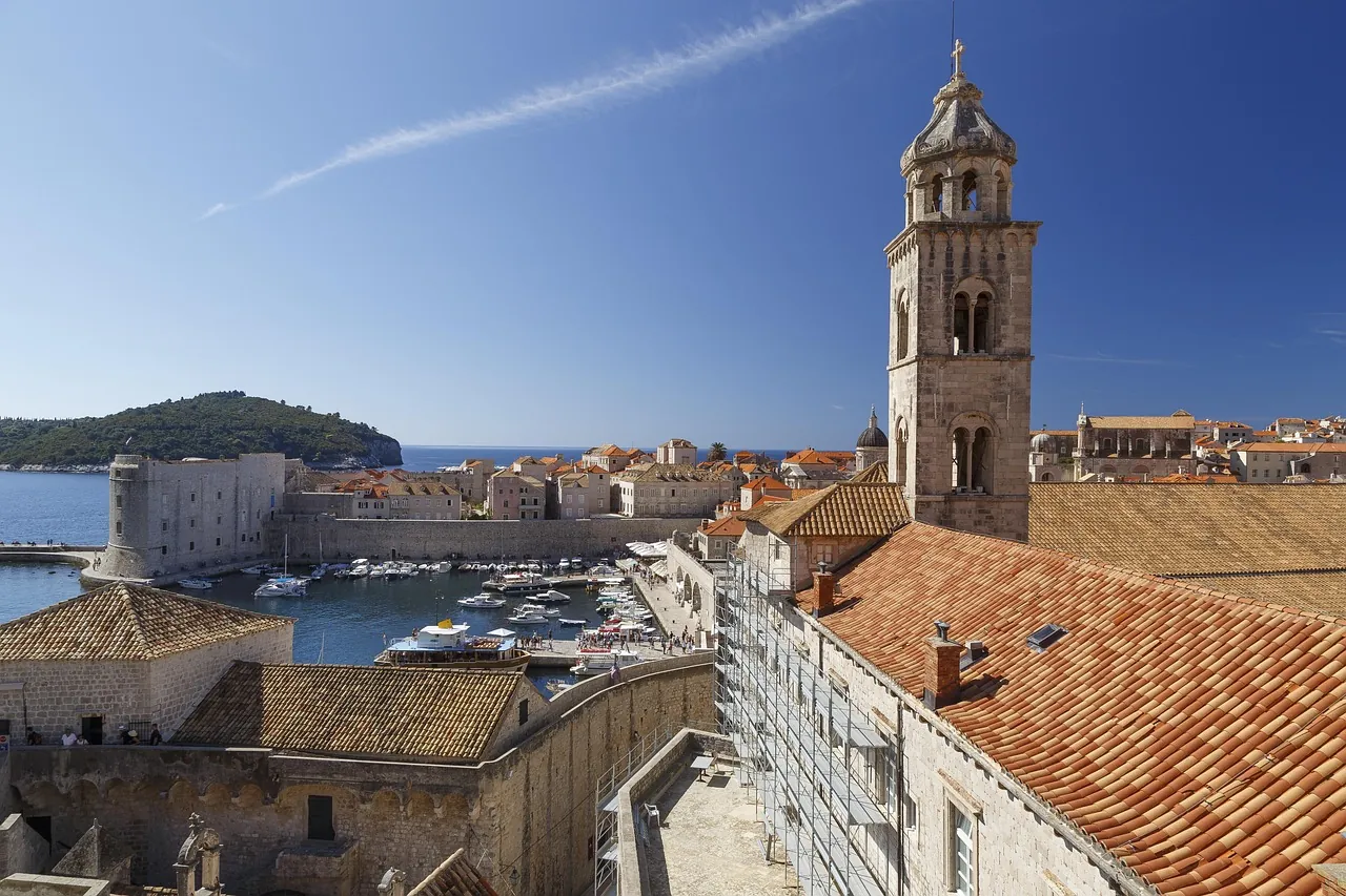 dubrovnik-old-town-rooftops-city-walls View over Dubrovnik Old Town rooftops and city walls with Lokrum Island in the background