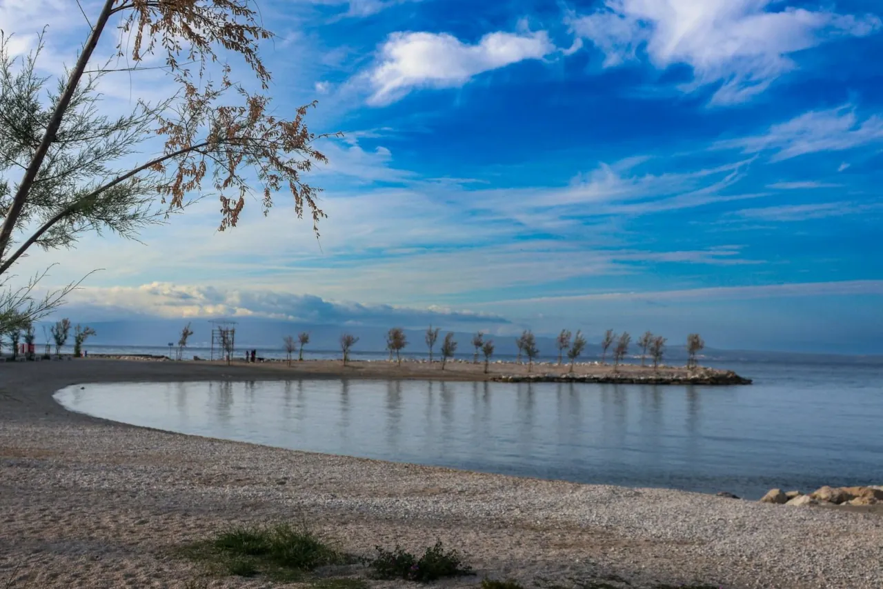 Pebble beach on the Croatian coast in Split with calm sea and natural shoreline
