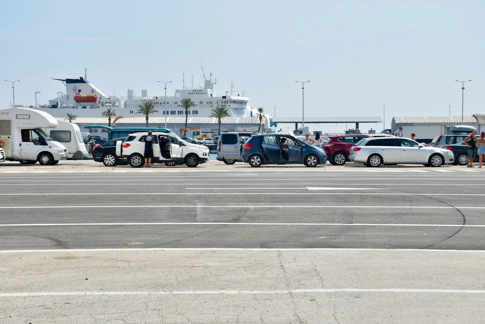 Cars waiting to board a ferry in port showing how Croatian ferry system works during summer