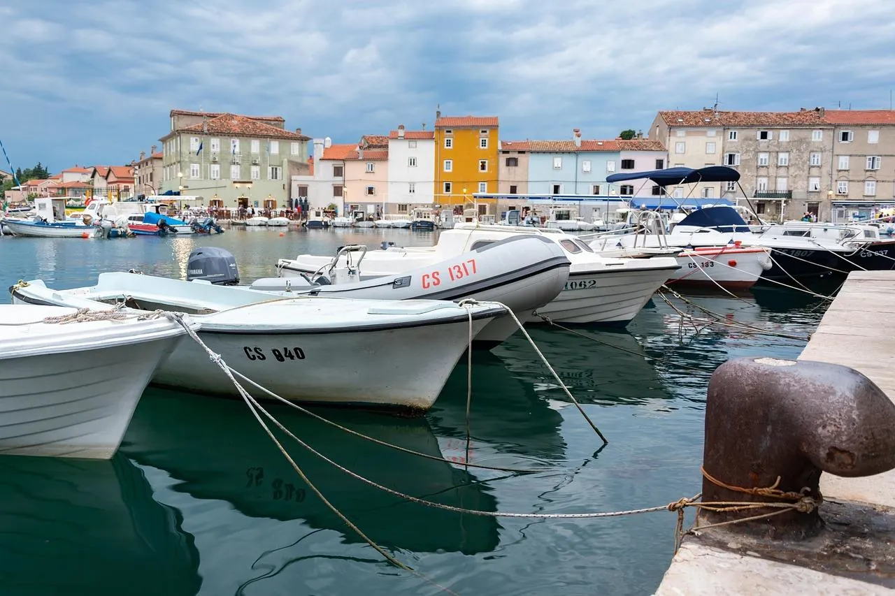 cres-island-coastline-croatia Small harbour on Cres Island, Croatia, with moored boats and colourful waterfront houses