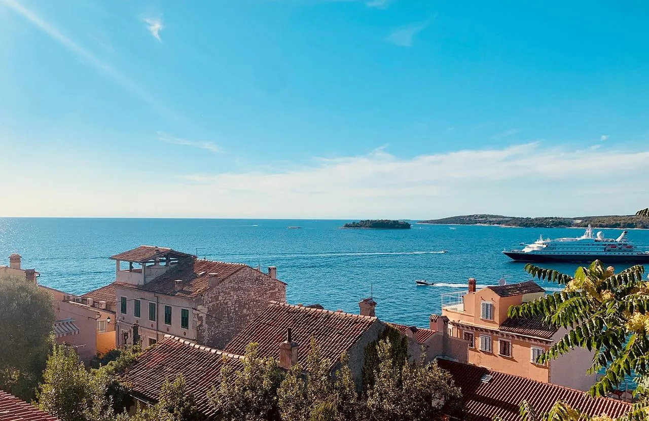 croatia-coastal-town-rovinj-view-with-ferry View over a coastal town Rovinj in Croatia with a ferry and cruise ship in the background