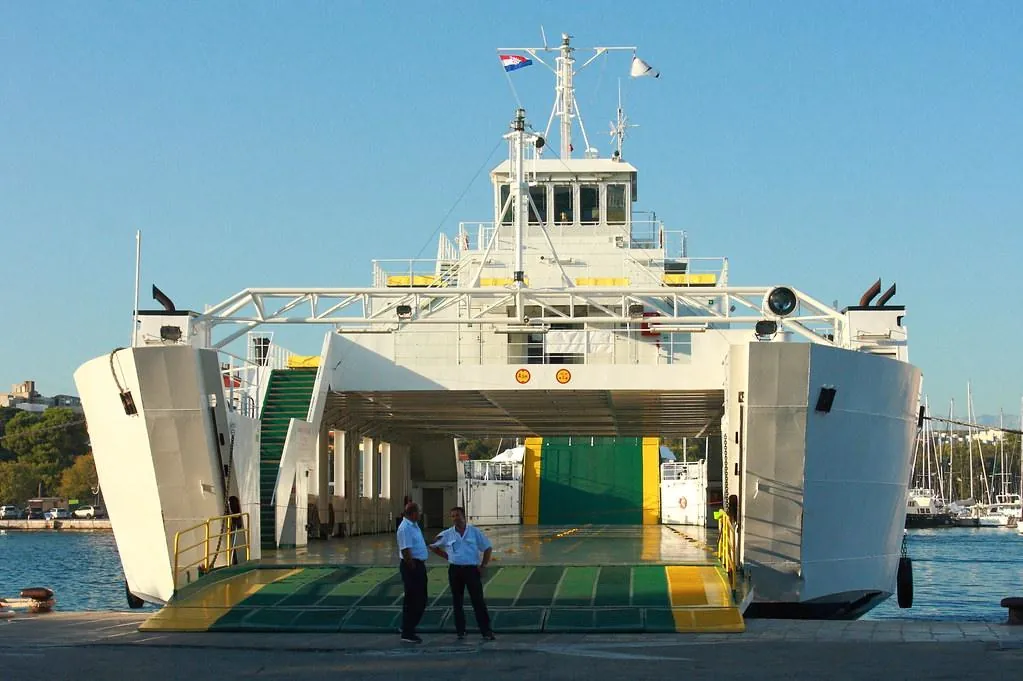 Croatian ferry with open ramp and crew standing by after boarding has closed