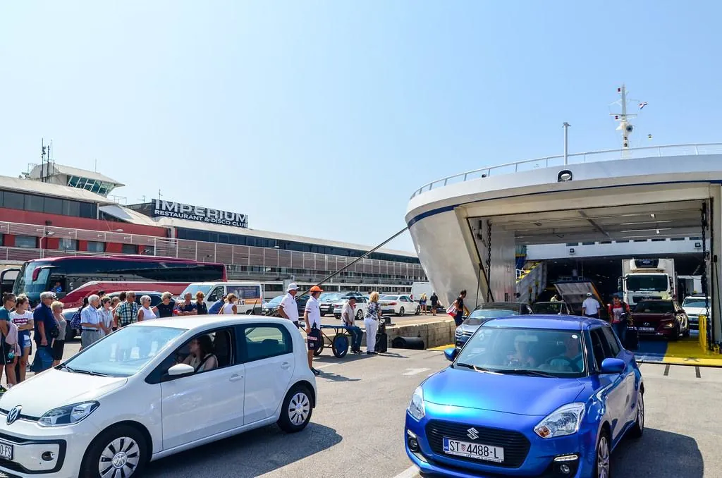 Typical Croatian ferry port with open vehicle lanes and boarding area