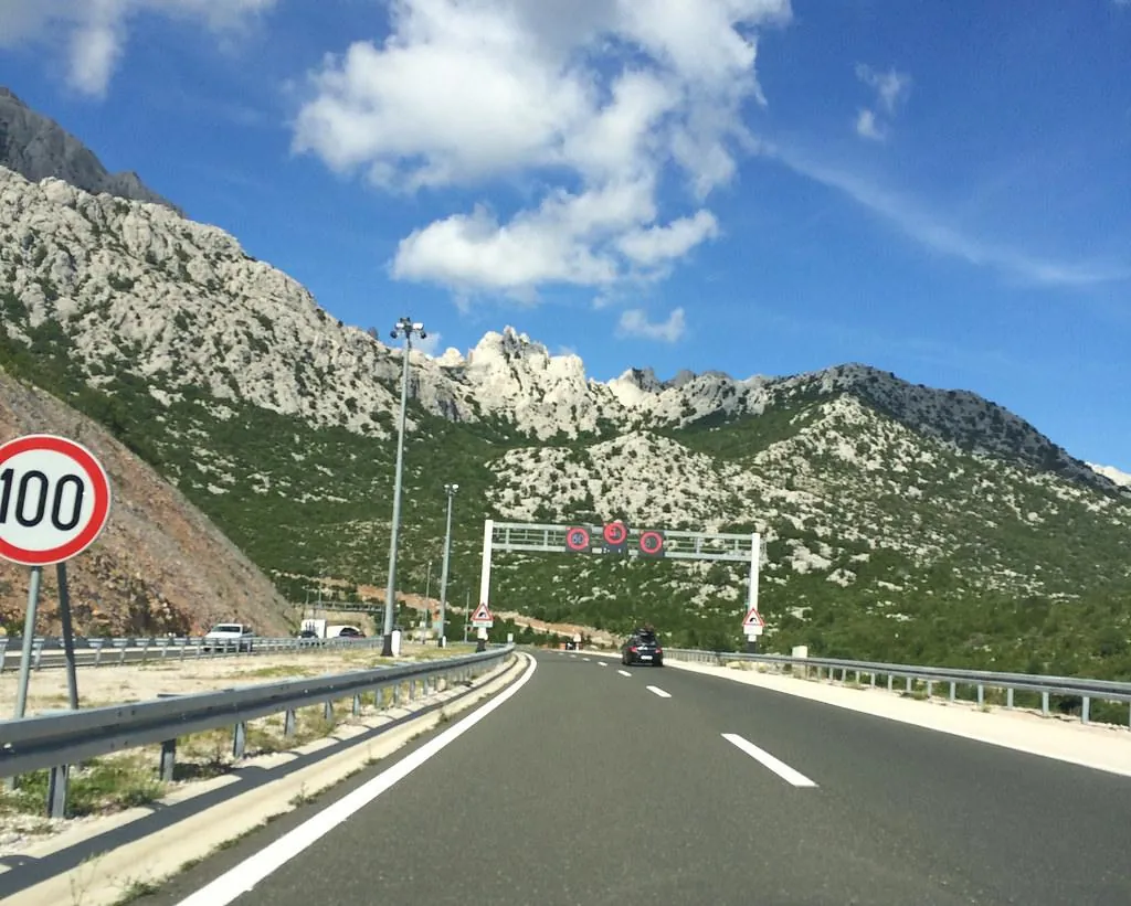 driving-highway-croatia-mountain-road Driving on a modern highway in Croatia with mountain landscape