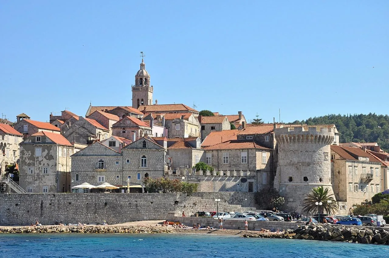 korcula-old-town-walls-croatia Korčula Old Town walls and stone buildings along the Adriatic coast, viewed from the sea in Croatia