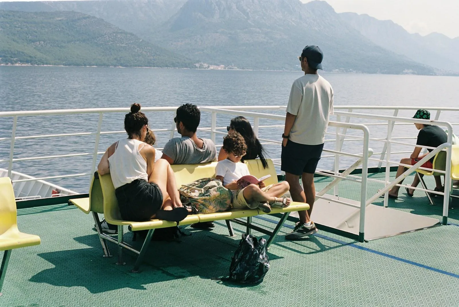 Passengers sitting on the outdoor deck of a Croatian ferry during the crossing