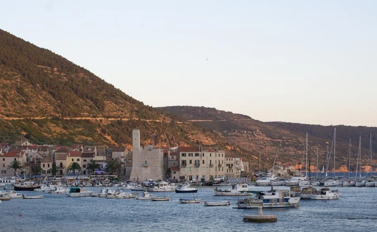 vis-island-harbour-croatia Vis island harbour in Croatia with boats, historic buildings and surrounding hills