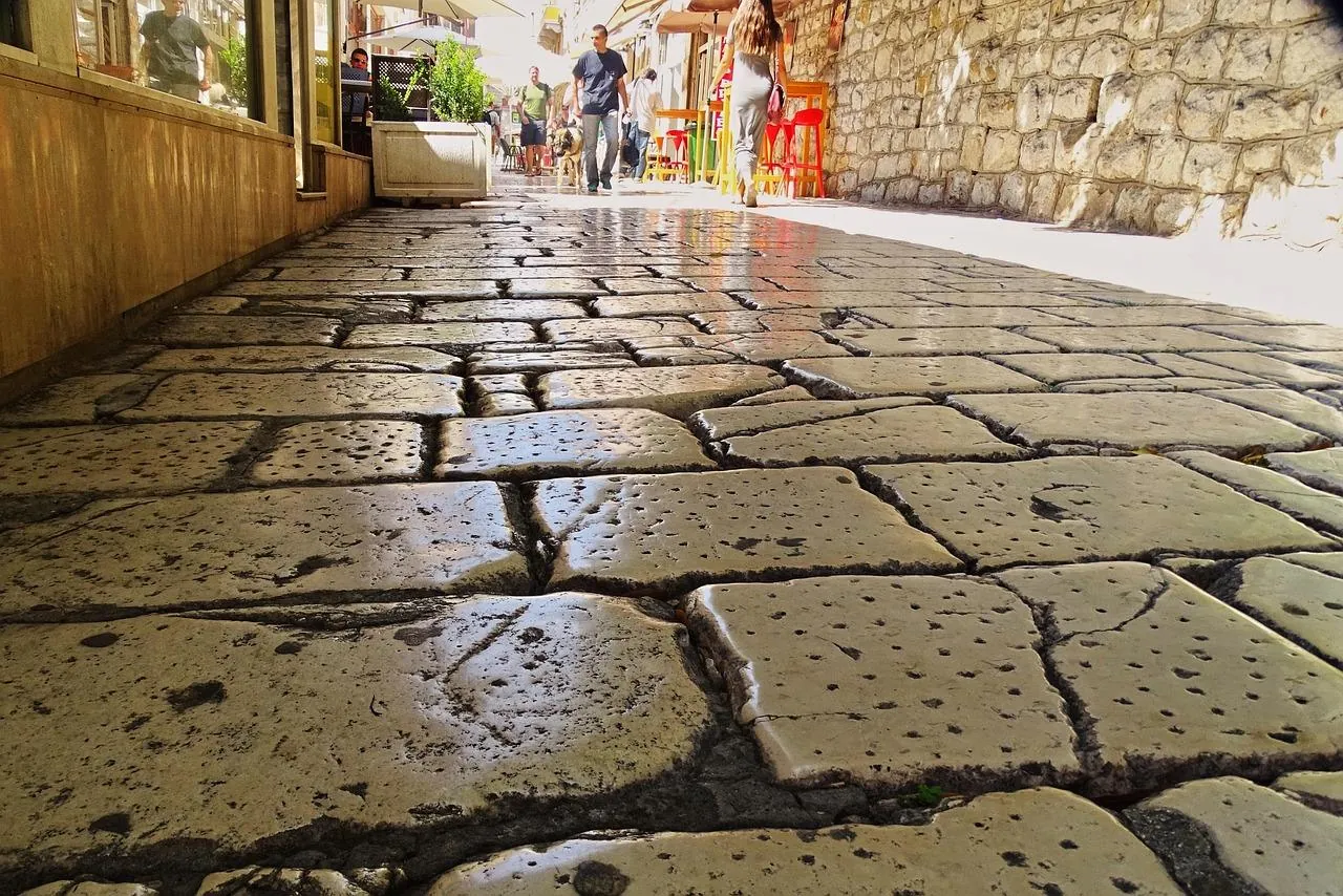 walking-in-old-town-split-croatia-stone-street Walking through a stone street in a historic old town Split in Croatia