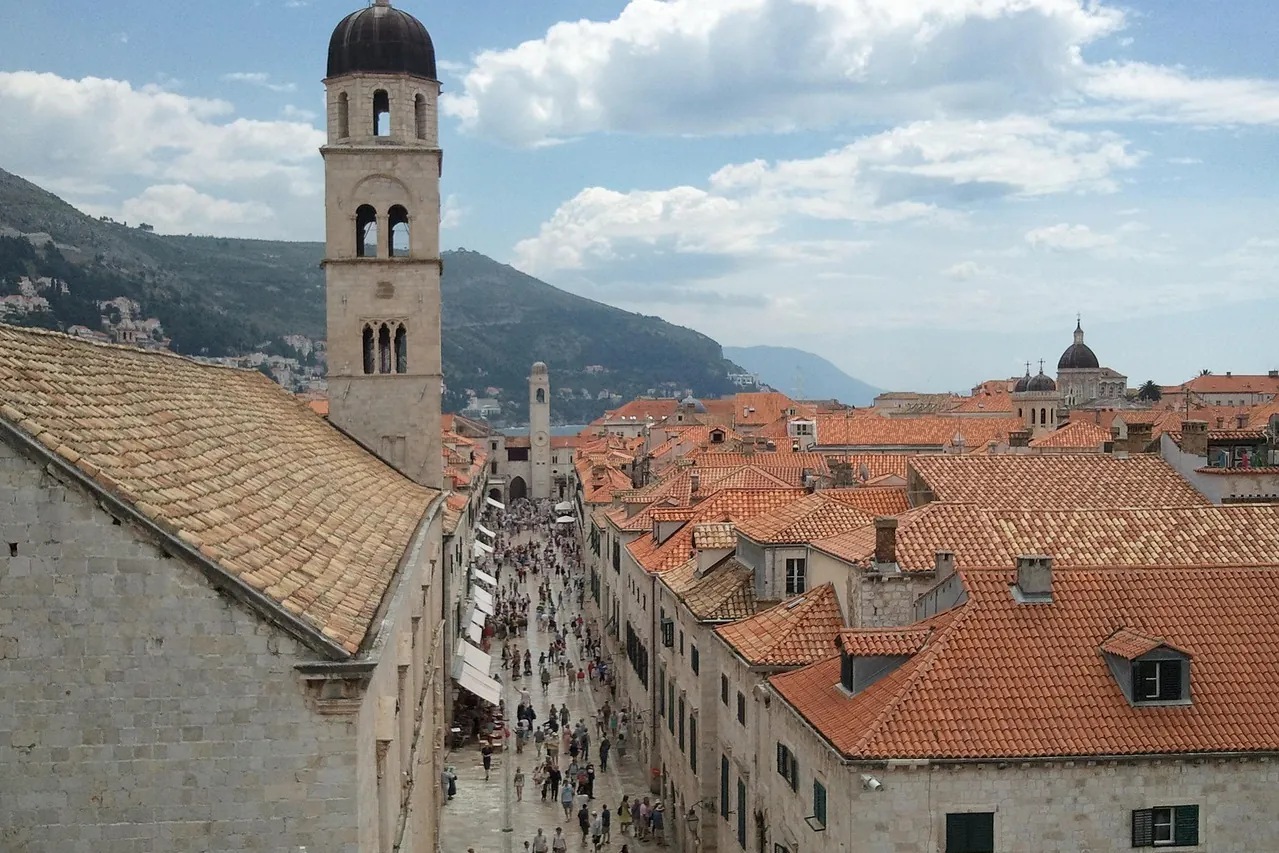 People walking along Stradun in Dubrovnik’s old town in the early season