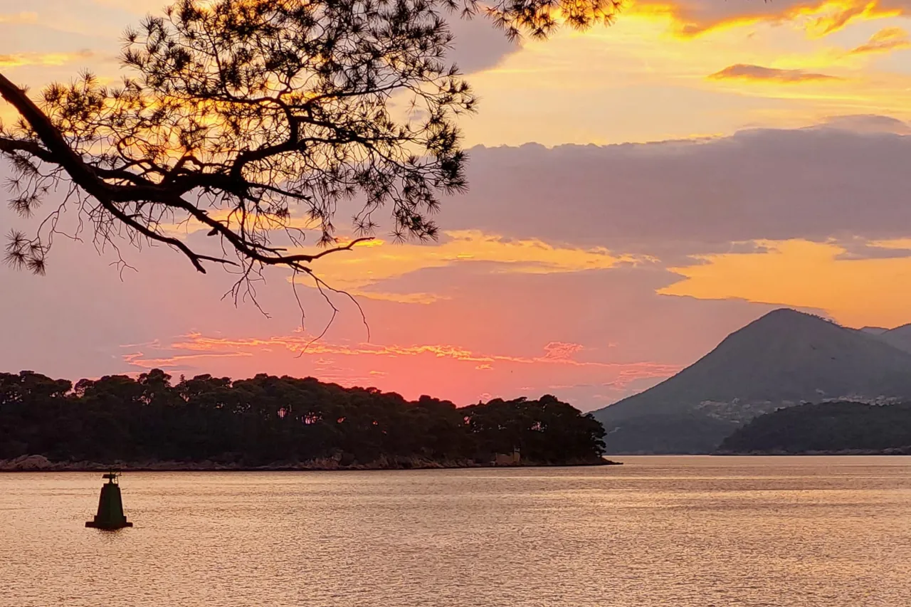 dubrovnik-croatia-sunset-babin-kuk-slow-travel-moment Quiet sunset view near Dubrovnik with pine trees overlooking the Adriatic Sea and nearby islands