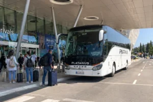 Shuttle bus from Dubrovnik airport with passengers and luggage outside the terminal