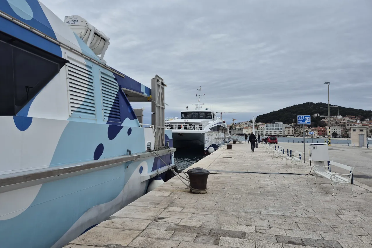 Catamarans docked at Split ferry port with passengers boarding in Croatia