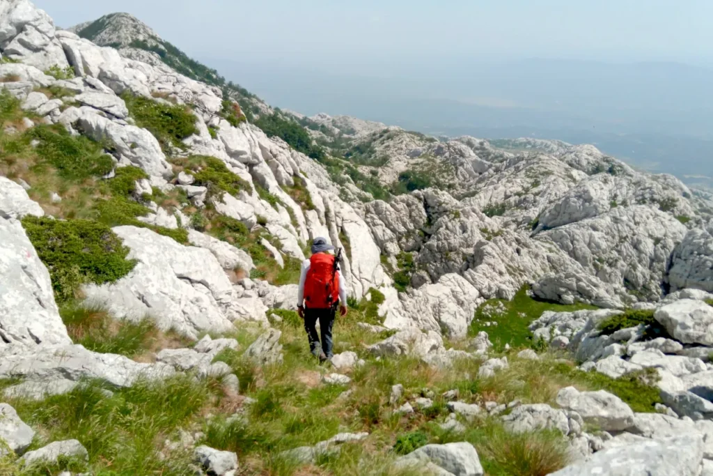 Hiker on the Little Prince Trail on southern Velebit after the Croatia hiking trail closed because of safety repairs and damaged climbing infrastructure.