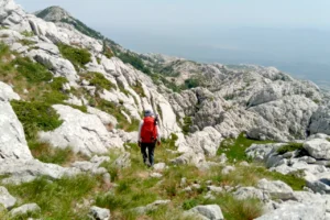 Hiker on the Little Prince Trail on southern Velebit after the Croatia hiking trail closed because of safety repairs and damaged climbing infrastructure.