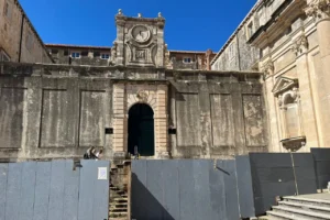 Protective fencing in front of historic buildings at Dubrovnik’s Jesuit complex during restoration works