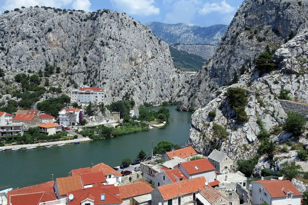 omis-cetina-river-aerial-view-coast-croatia View of Omiš in Croatia with the Cetina River surrounded by cliffs and red-roofed houses