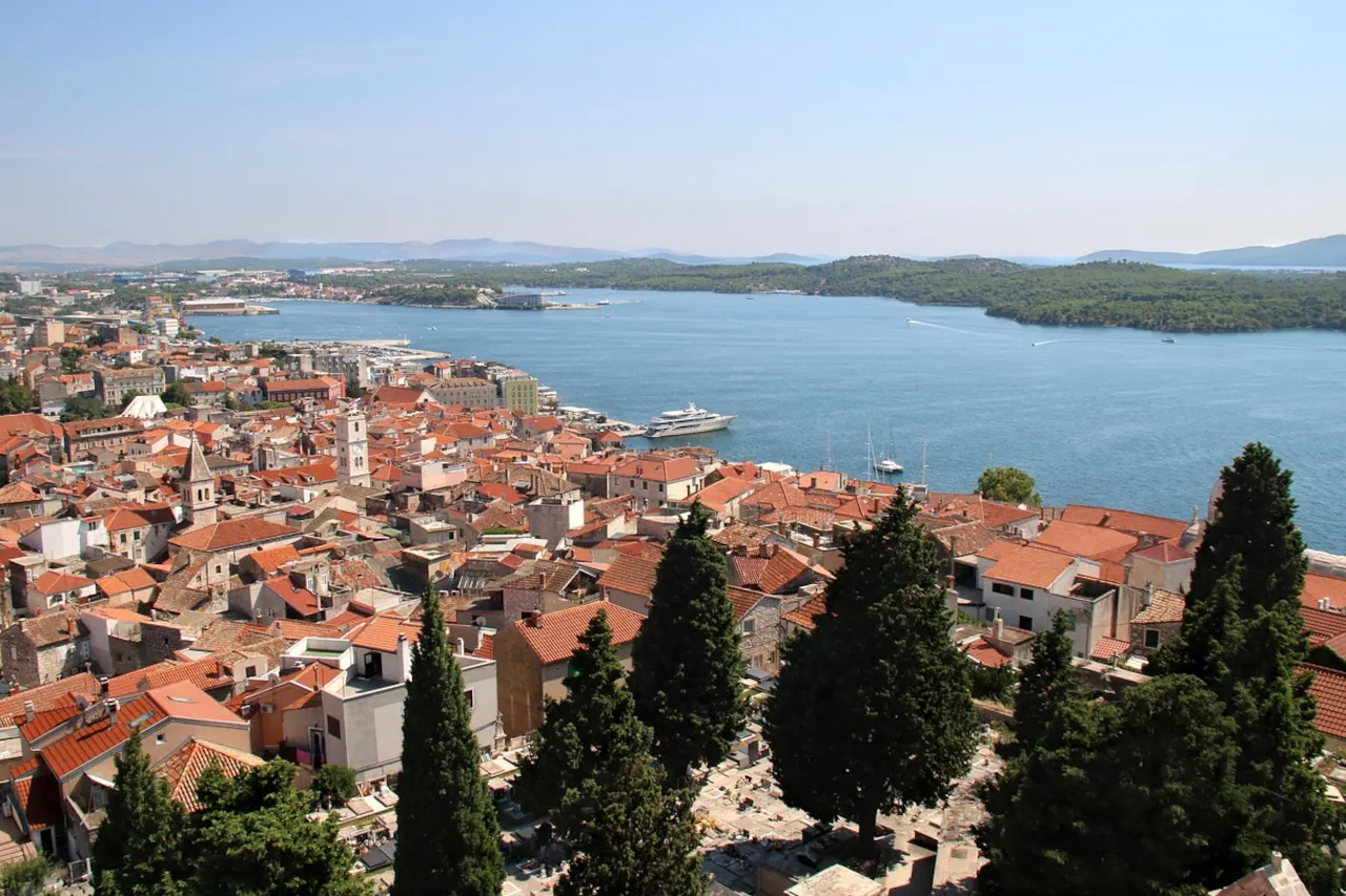 sibenik-croatia-old-town-sea-view-dalmatia View over Šibenik Croatia old town with red rooftops and the Adriatic Sea in the background