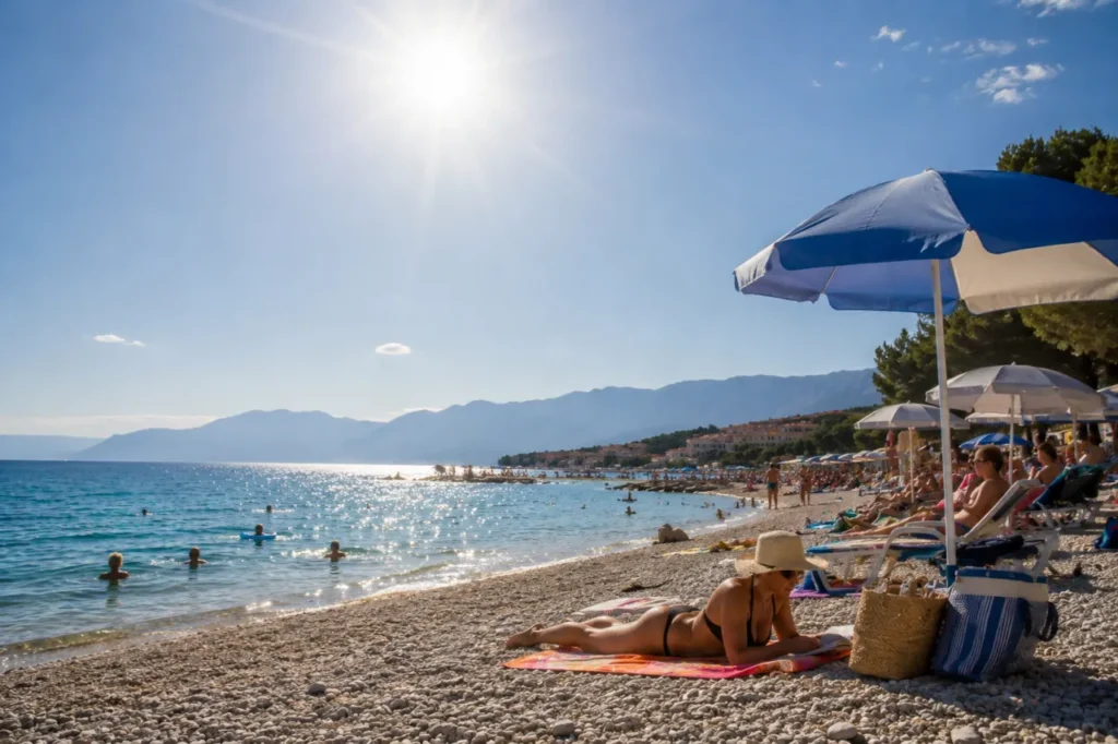 People sheltering from the Croatia heatwave under beach umbrellas on the Adriatic coast