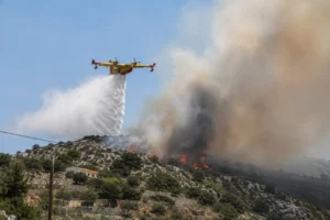 Croatian Canadair in flight dropping water over a wildfire