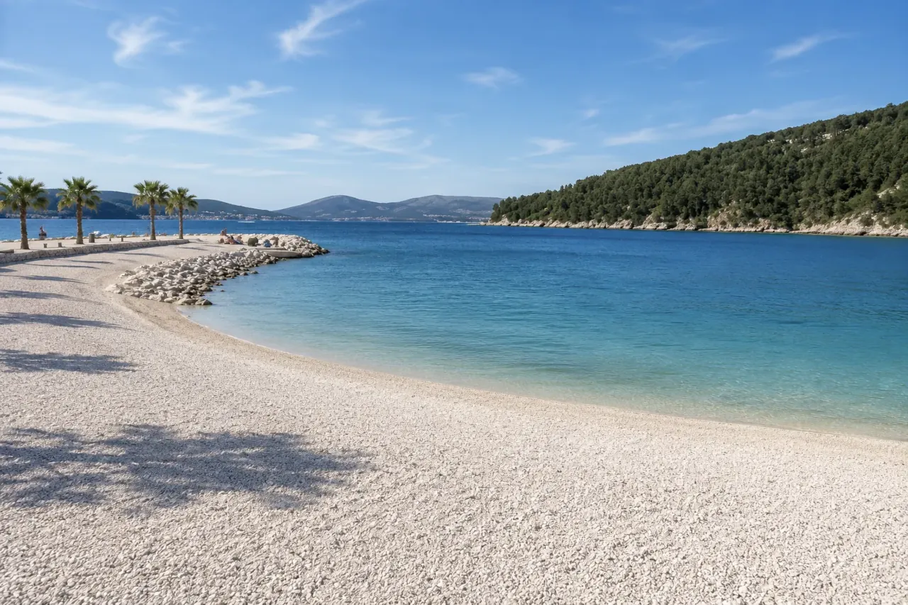 kasjuni-beach-in-split-croatia-seafront-view Kašjuni Beach in Split, Croatia, with turquoise Adriatic Sea, white pebble beach and Marjan peninsula in the background.