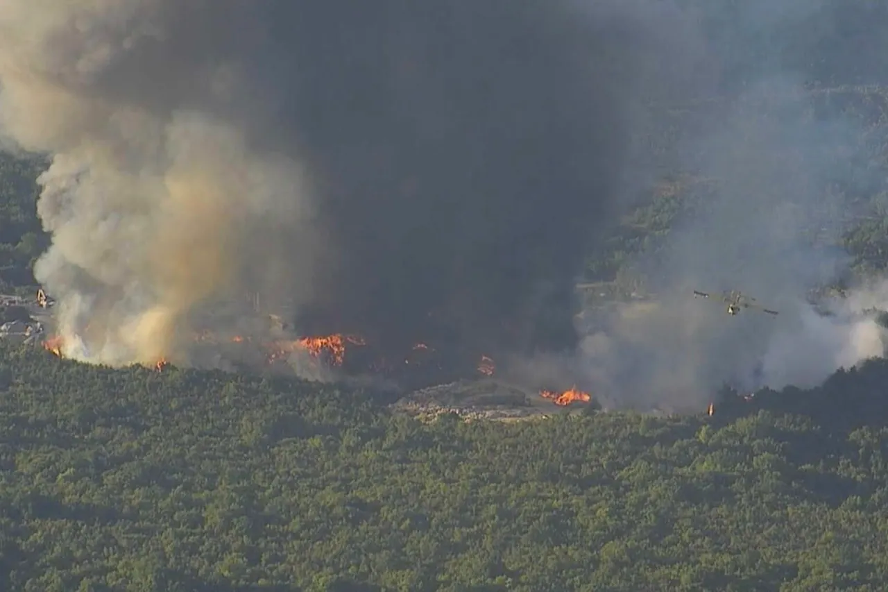 Wildfire near Split burning near Labin Dalmatinski as thick smoke rises above the surrounding vegetation