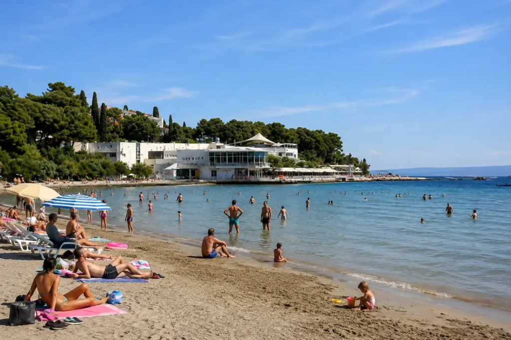 Summer day at Bačvice Beach in Split with sunbathers and swimmers
