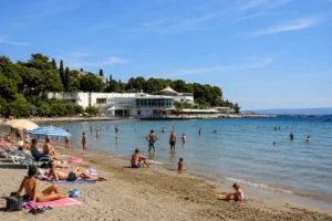 Summer day at Bačvice Beach in Split with sunbathers and swimmers