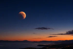Partial lunar eclipse in Croatia visible low above the horizon before dawn