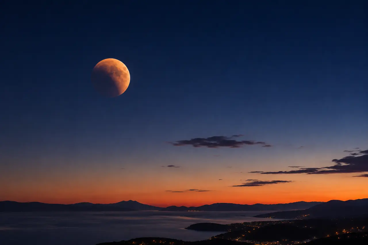 Partial lunar eclipse in Croatia visible low above the horizon before dawn